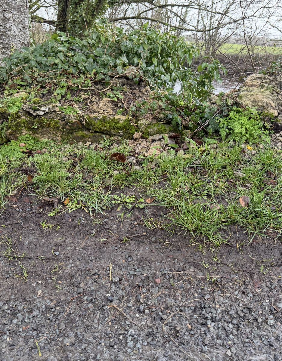 A later close view of the stone edge beside the road